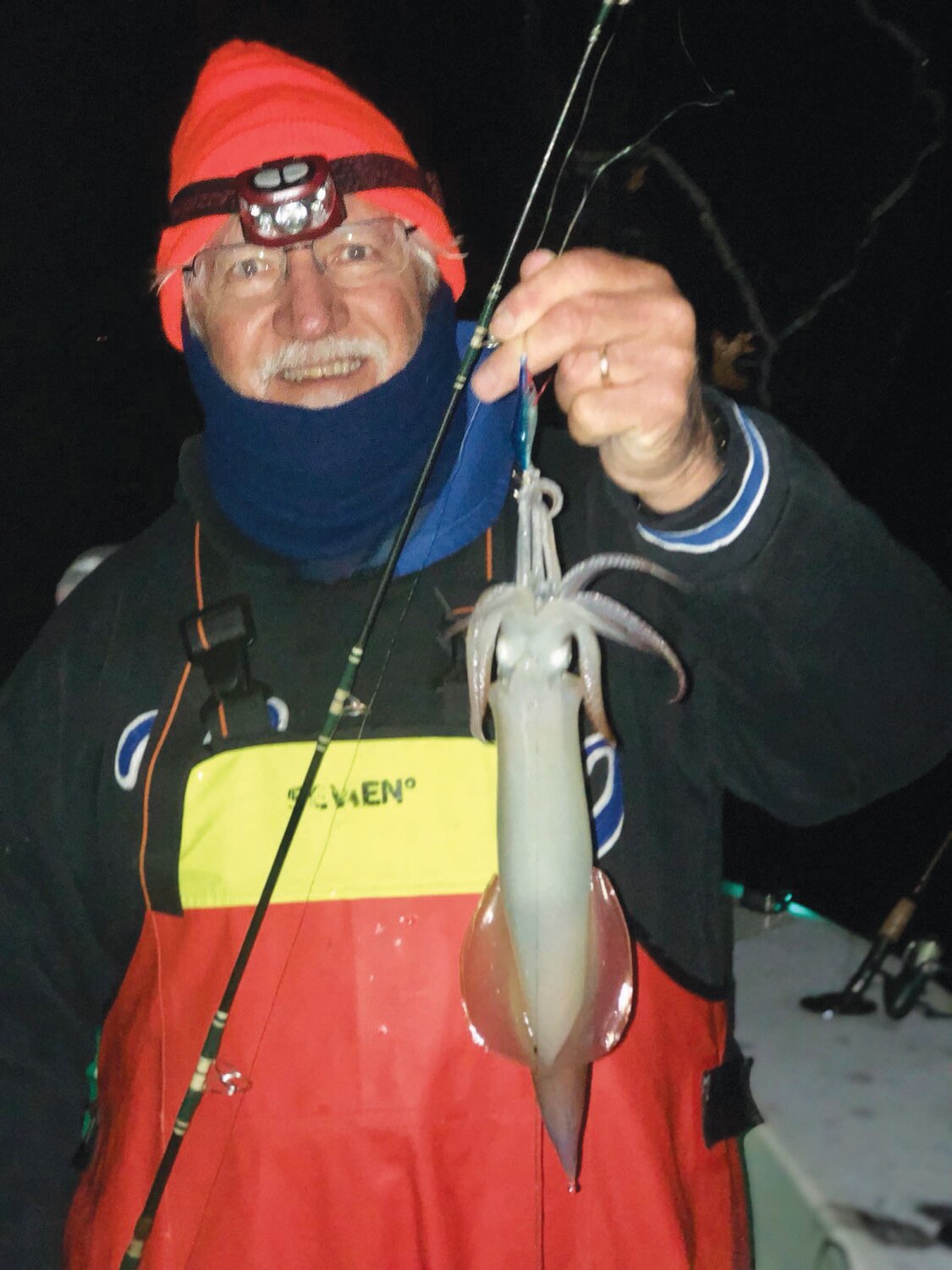 THE SQUID ARE IN: Phil Duckett Jr. of Portsmouth with a squid he caught Friday night fishing the Newport Bridge area with squid fishing expert Greg Vespe of Tiverton.